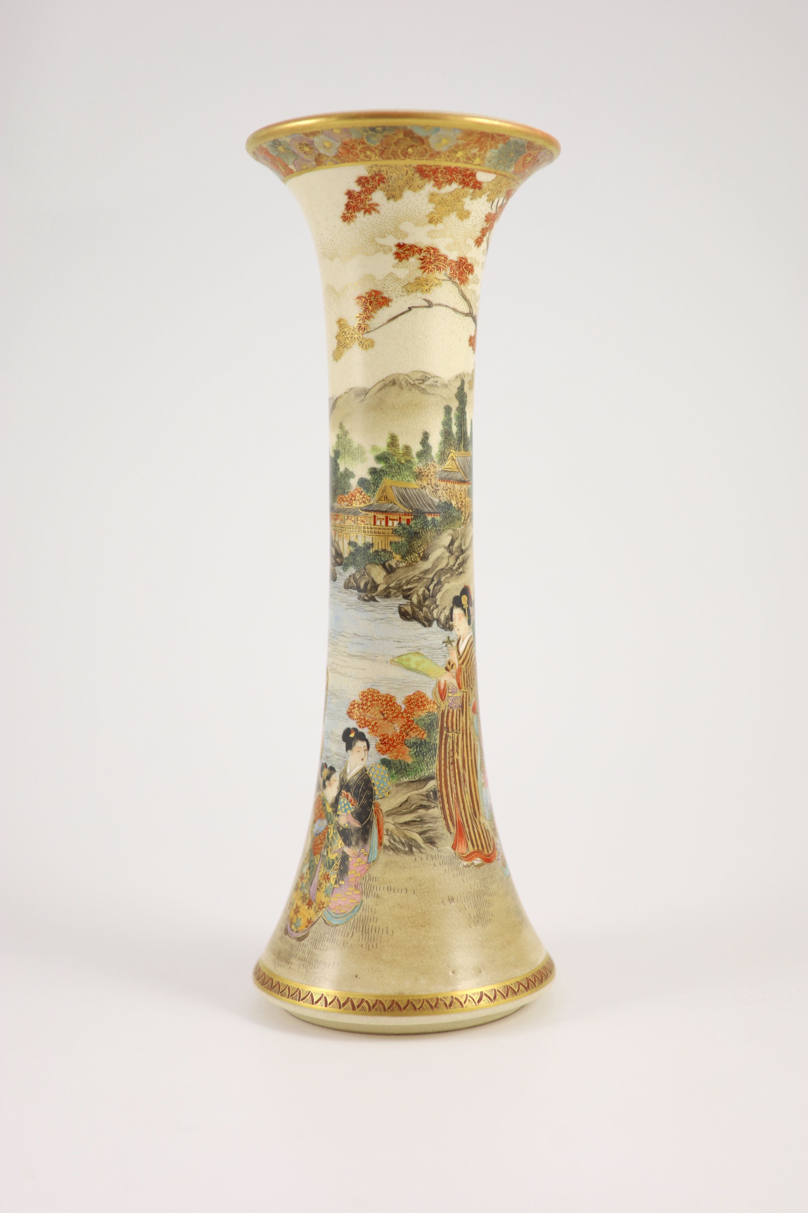 A Japanese satsuma earthenware trumpet vase by Kizan, Meiji period. The body painted and gilt with bijin and children in a lakeside landscape beneath a floral band rim, iron red and gilt signature to base. 30 cm high x 1